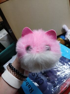Pomsies interactive plush toy features soft pink fur and bright eyes that light